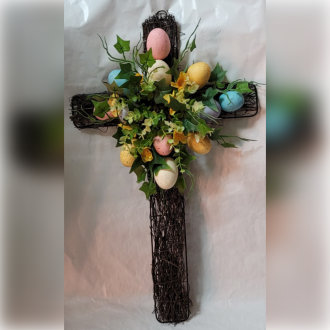 decorative flowers and eggs on a cross